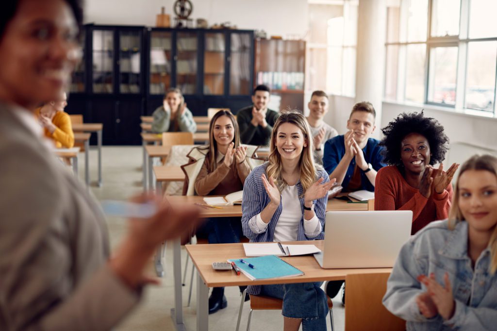 Group of happy students attending class